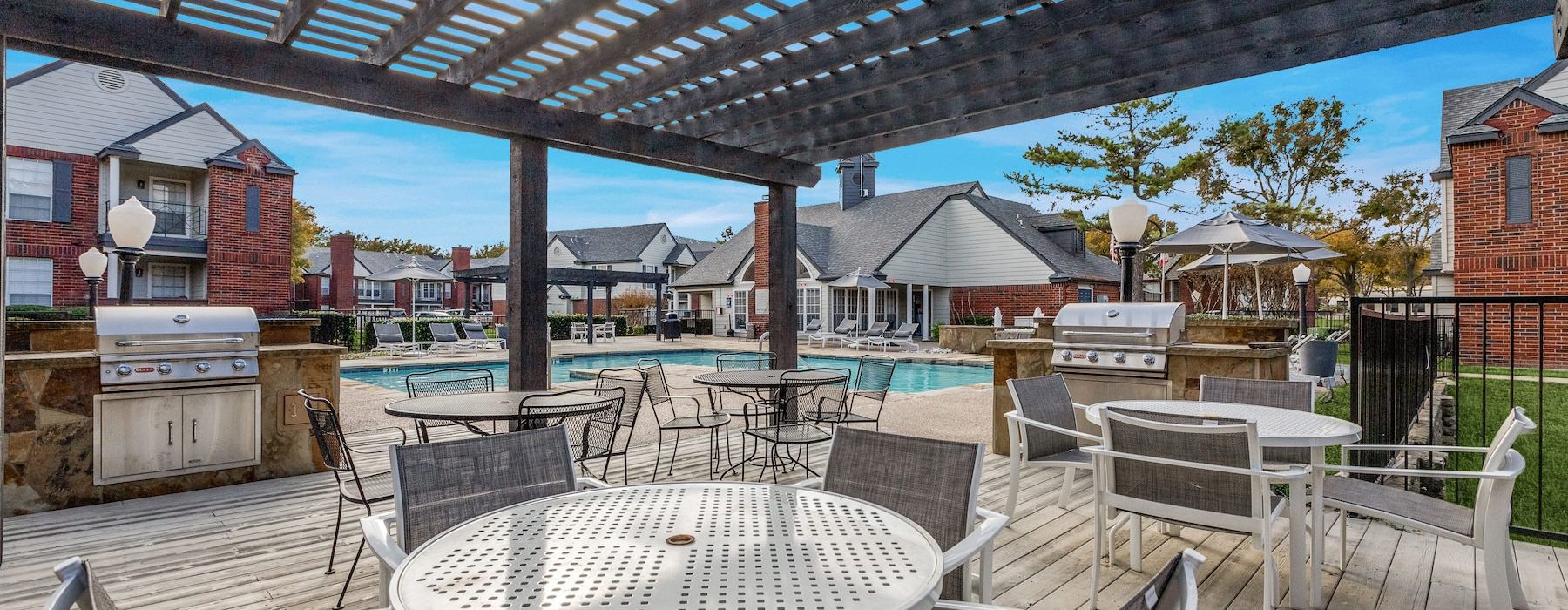 a patio with tables and chairs
