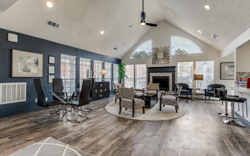 a room with a fireplace and chairs